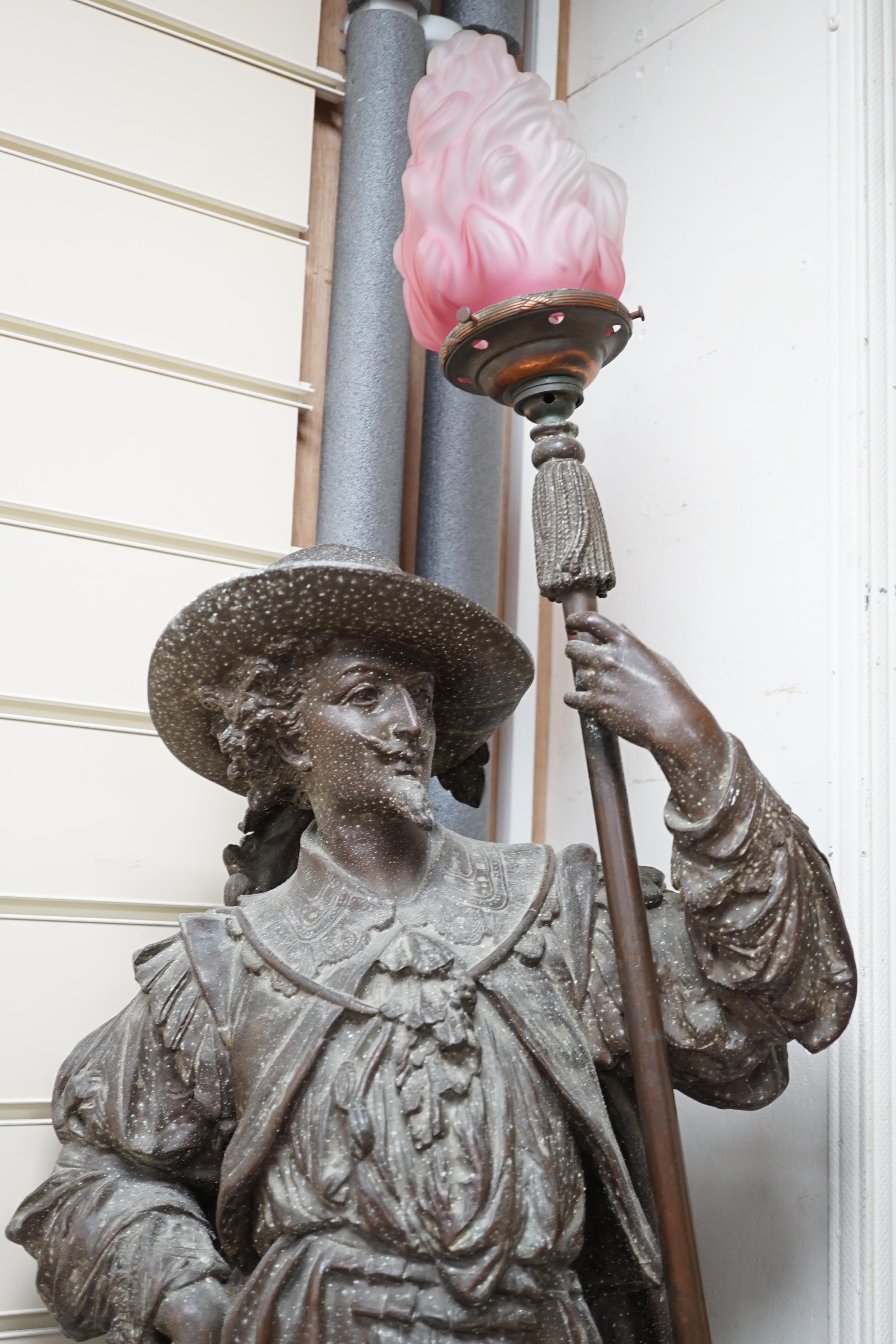 A 20th century spelter figural Cavalier floor lamp, with glass torch shade, approximately 108cm high